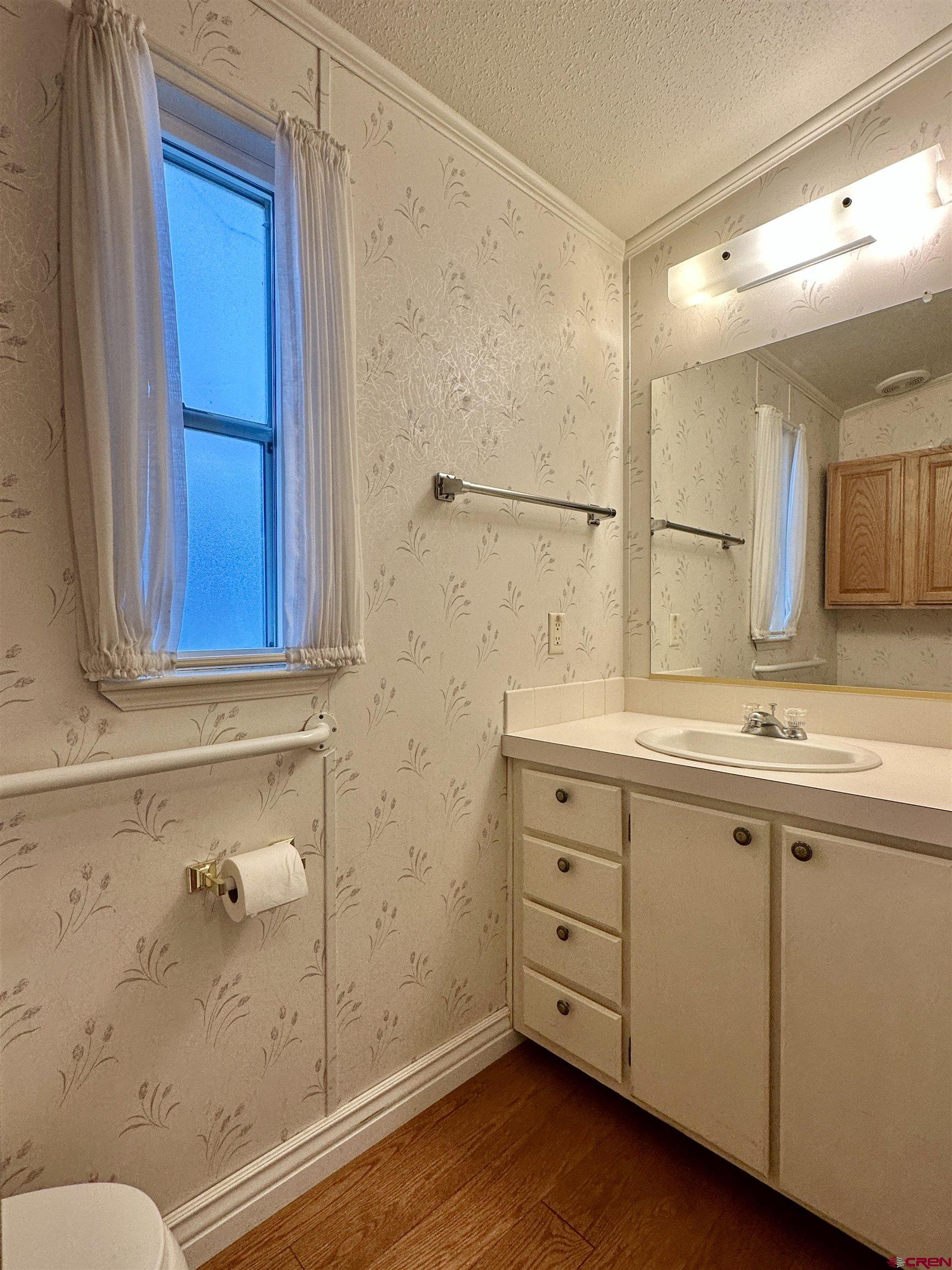 9427 2100th Road Austin, CO 81410 - Photo 25 of 42 a bathroom with a sink a mirror and a shower