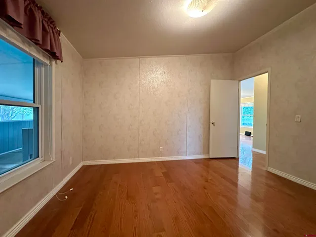 a view of wooden floor and brick walls