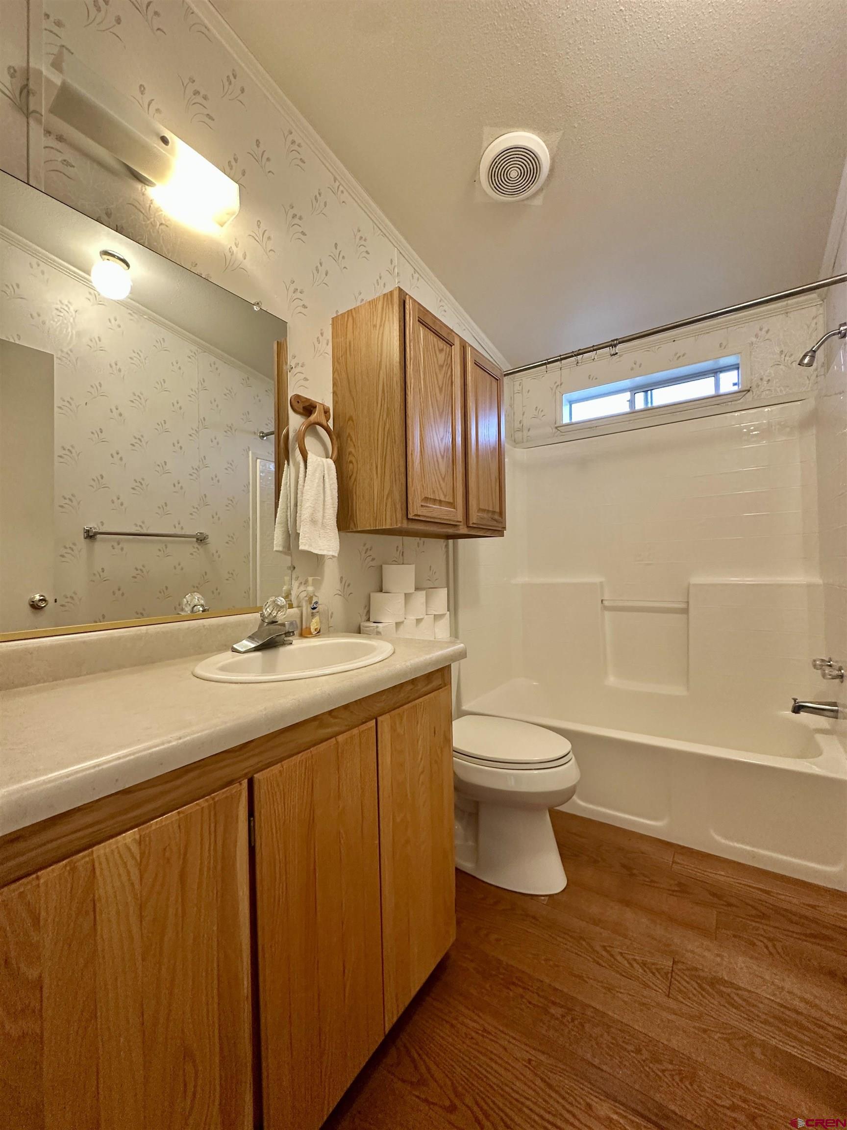 9427 2100th Road Austin, CO 81410 - Photo 30 of 42 a bathroom with a toilet sink and mirror