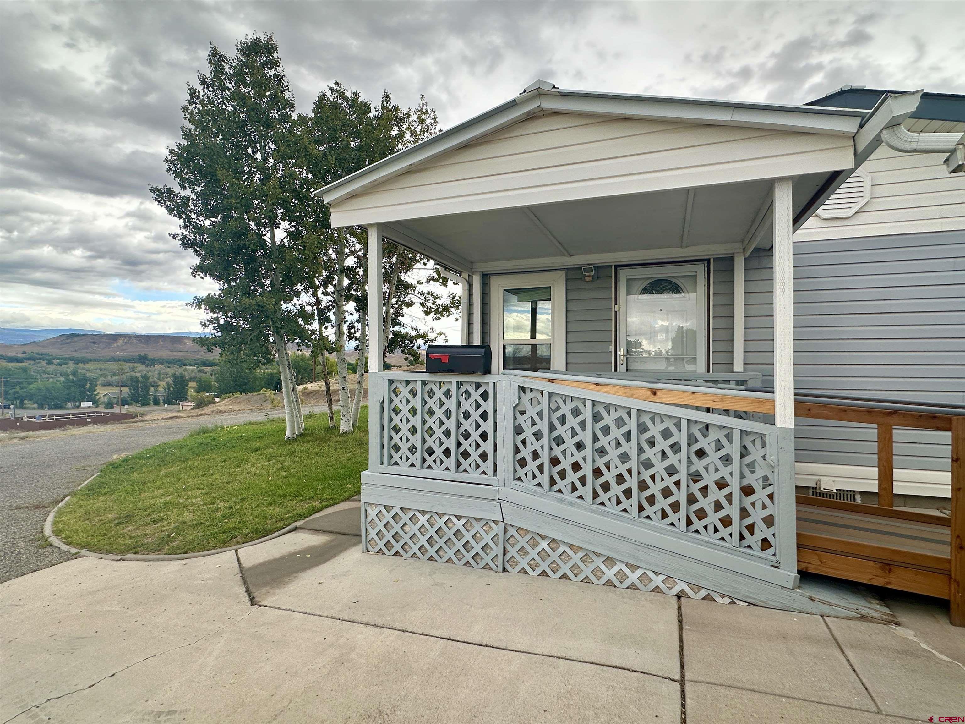 9427 2100th Road Austin, CO 81410 - Photo 6 of 42 a front view of a house with a garden
