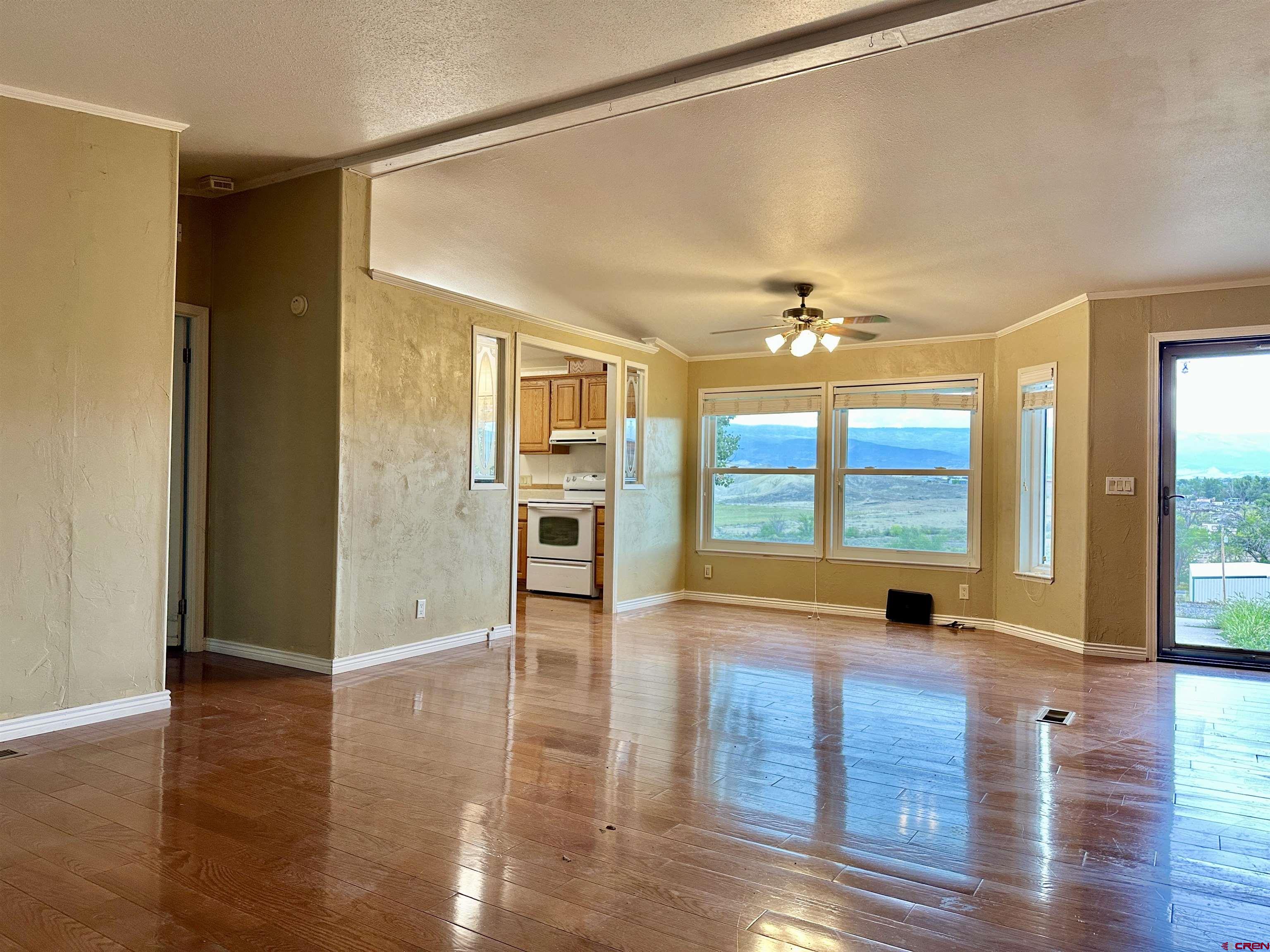 9427 2100th Road Austin, CO 81410 - Photo 7 of 42 a view of an empty room with a window and wooden floor