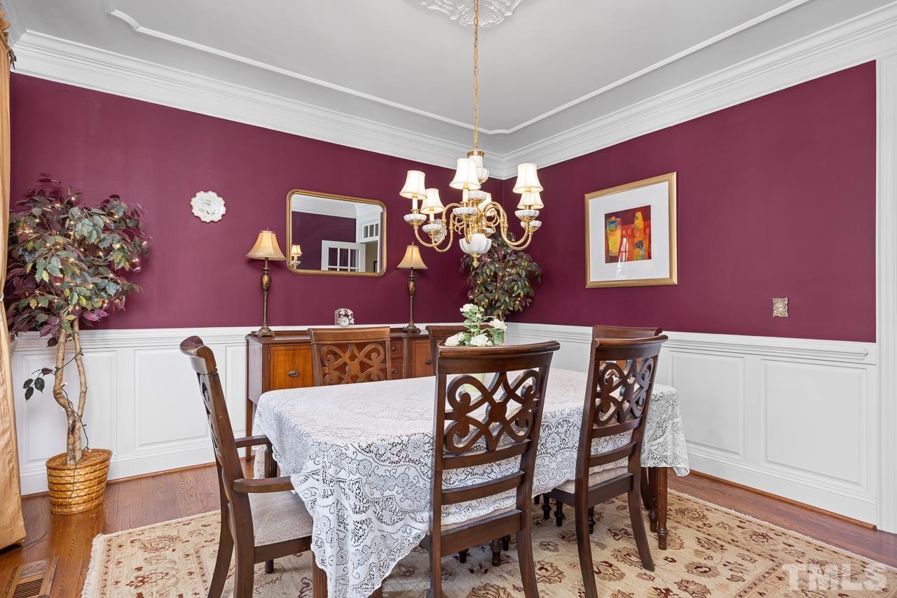 301 Medoc Lane Raleigh, NC 27615 - Photo 13 of 55 a view of a dining room with furniture and a chandelier