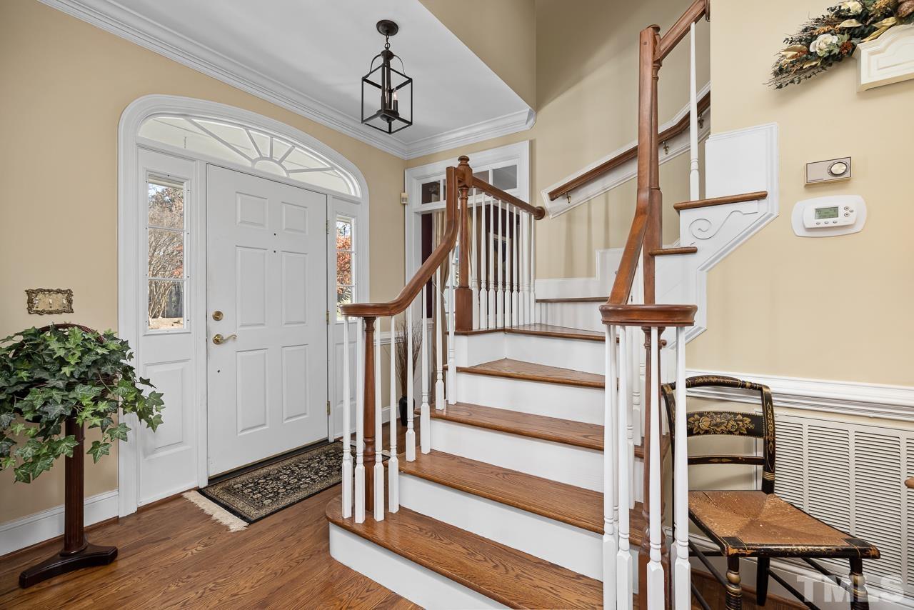301 Medoc Lane Raleigh, NC 27615 - Photo 3 of 55 a view of entryway with wooden floor and stairs