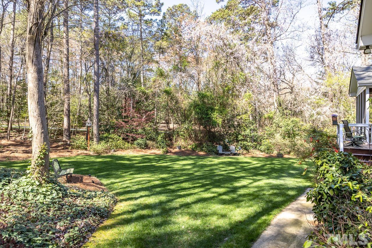 301 Medoc Lane Raleigh, NC 27615 - Photo 32 of 55 a backyard of a house with a yard and outdoor seating