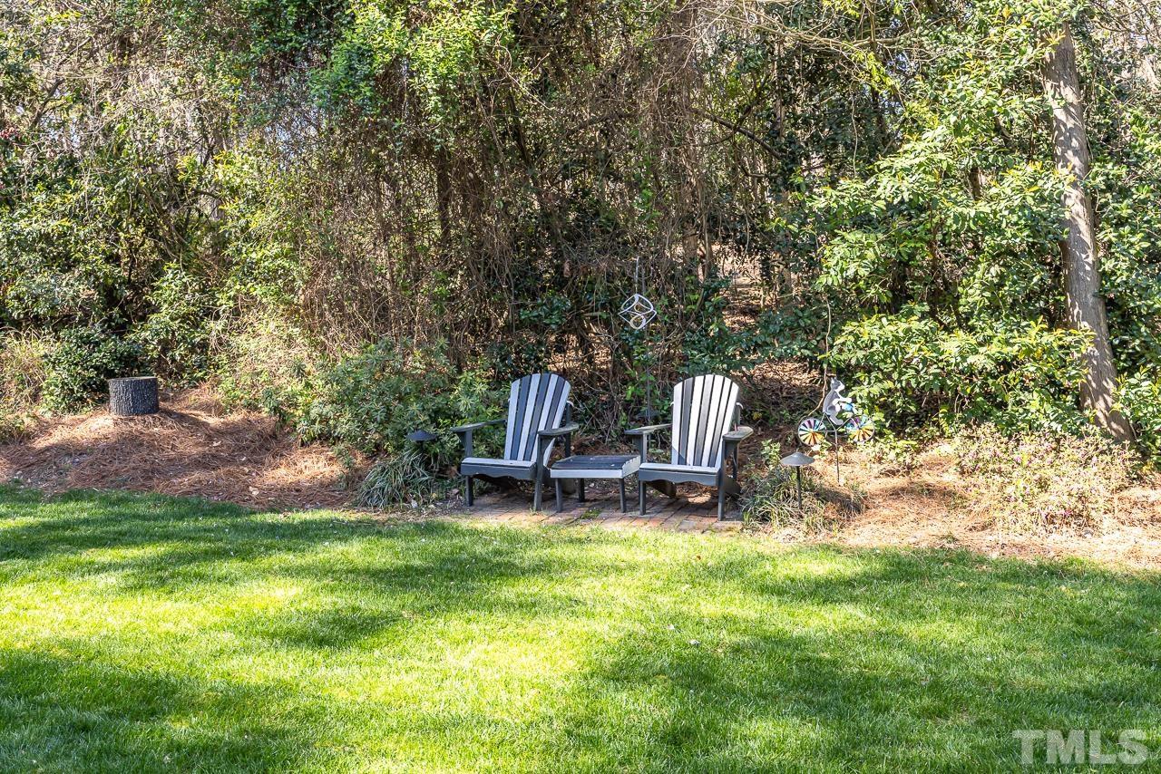 301 Medoc Lane Raleigh, NC 27615 - Photo 34 of 55 a view of a backyard with a bench and some trees