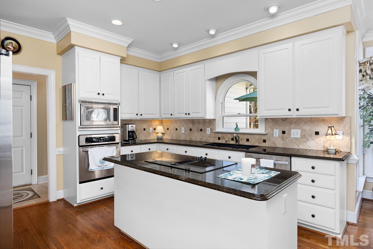 301 Medoc Lane Raleigh, NC 27615 - Photo 10 of 55 a kitchen with stainless steel appliances granite countertop a stove a sink dishwasher and a refrigerator