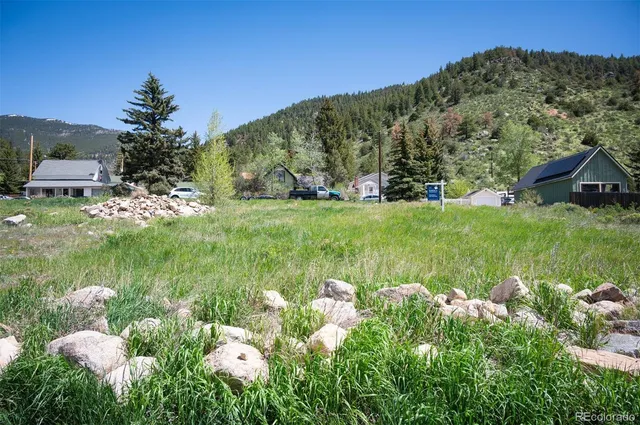a backyard of a house with a yard and outdoor seating