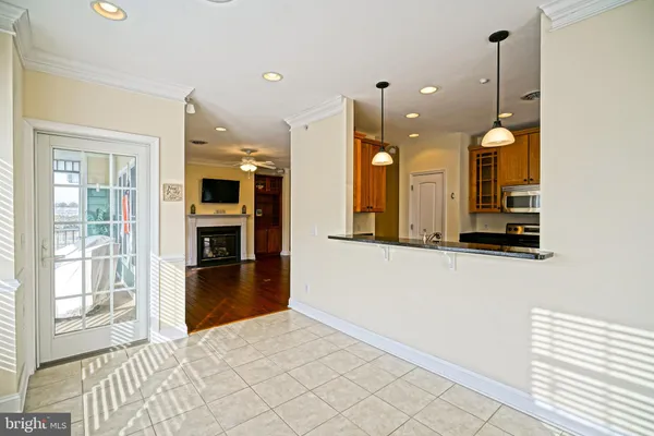 a view of a kitchen with cabinets and wooden floor