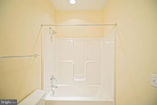 a view of a bathroom with wooden floor and cabinet