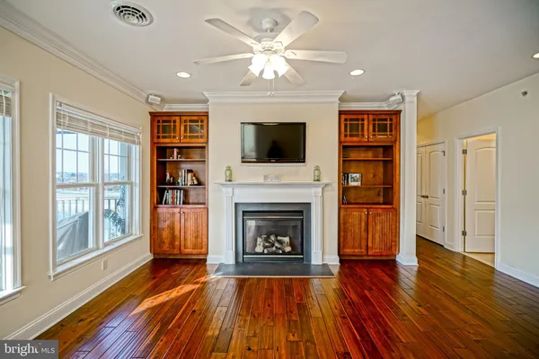 a living room with furniture fireplace and flat screen tv