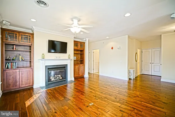a living room with furniture fireplace and flat screen tv