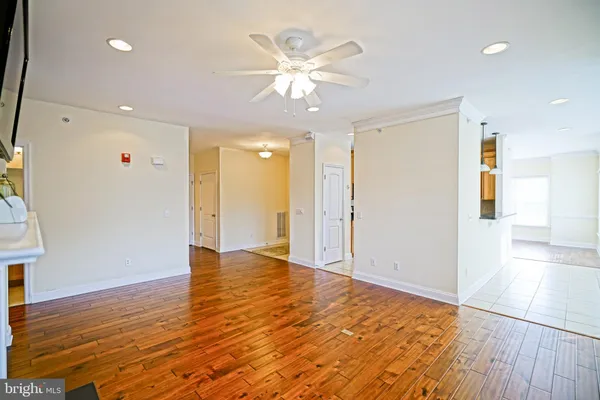 a view of an empty room and wooden floor