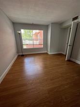 1001 Crystal Way, Unit B Delray Beach, FL 33444 - Photo 11 of 12 an empty room with wooden floor and windows