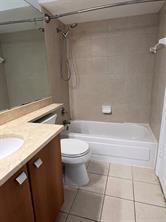 1001 Crystal Way, Unit B Delray Beach, FL 33444 - Photo 4 of 12 a bathroom with a granite countertop bathtub and toilet