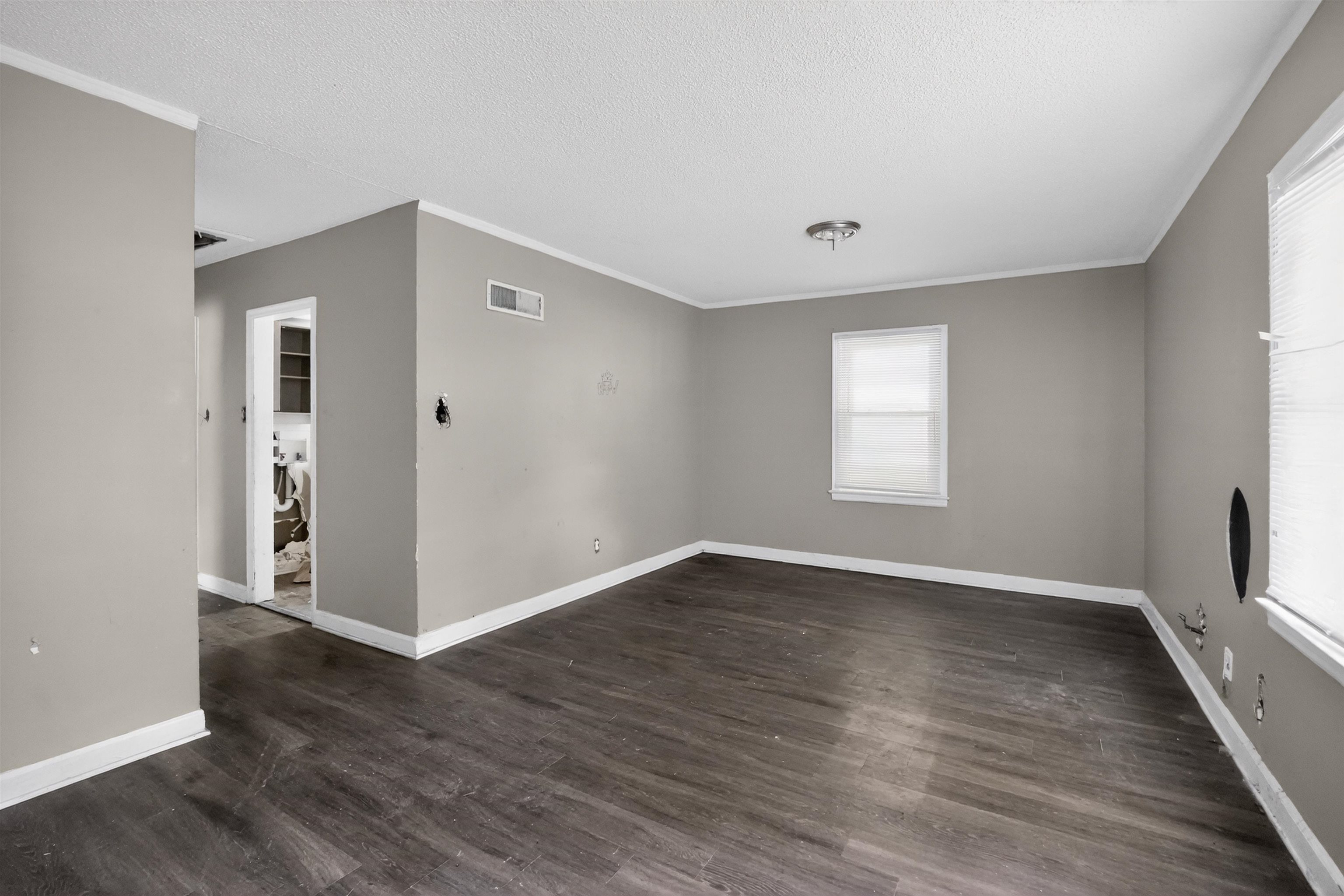 949 Sumter Street Memphis, TN 38122 - Photo 20 of 33 Open living area featuring wood-finish flooring, neutral gray walls, and white trim