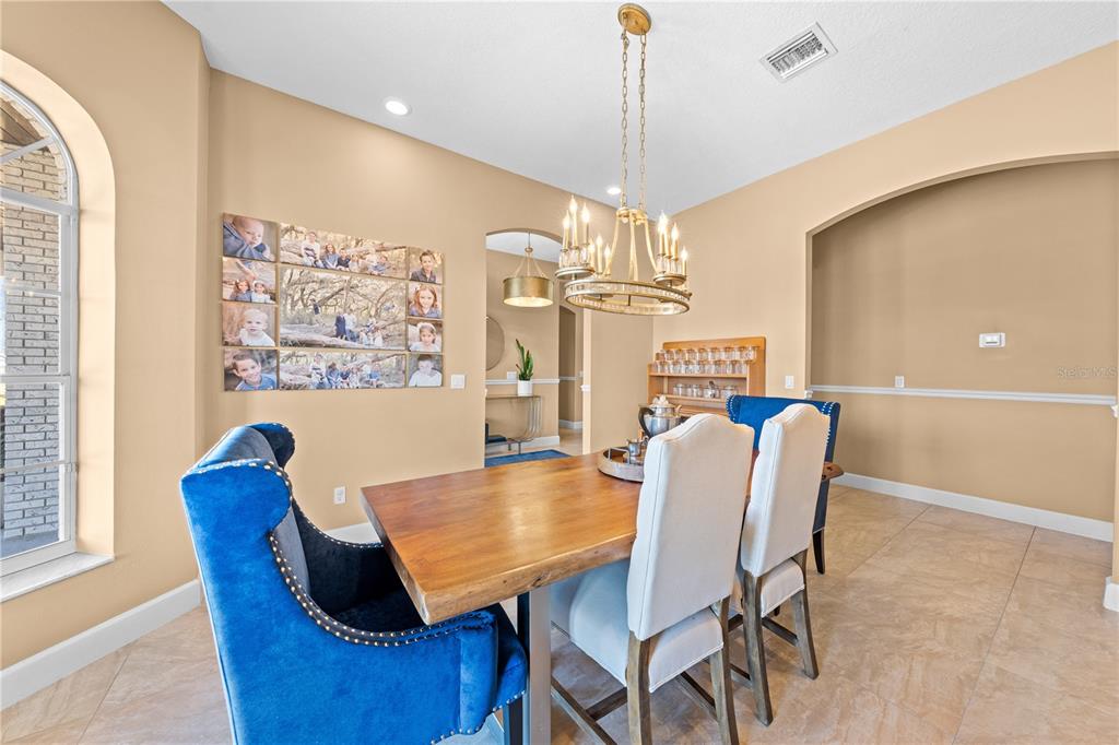 4231 Albritton Road St. Cloud, FL 34772 - Photo 13 of 94 a view of a dining room with furniture window and wooden floor