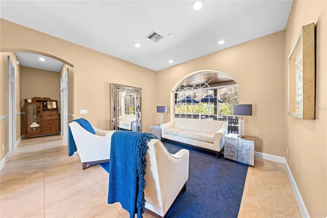 a living room with furniture a rug and a flat screen tv
