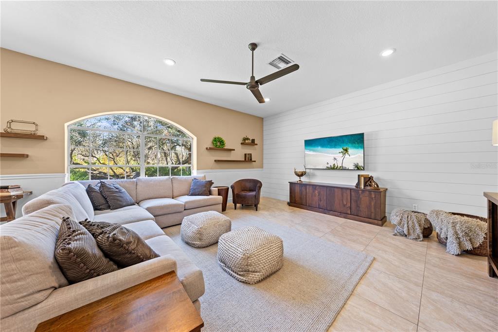 4231 Albritton Road St. Cloud, FL 34772 - Photo 29 of 94 a living room with furniture a rug and a flat screen tv