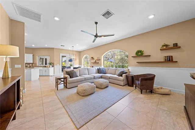 a open kitchen with stainless steel appliances granite countertop a stove a sink and a microwave