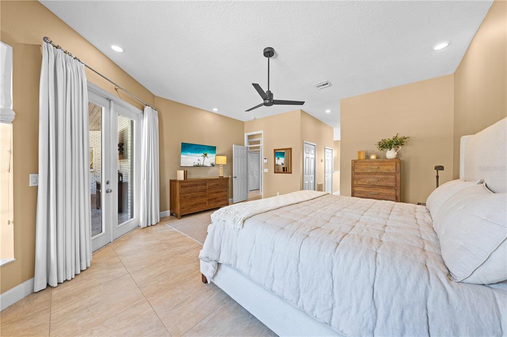 4231 Albritton Road St. Cloud, FL 34772 - Photo 36 of 94 a spacious bedroom with a bed and a flat tv screen