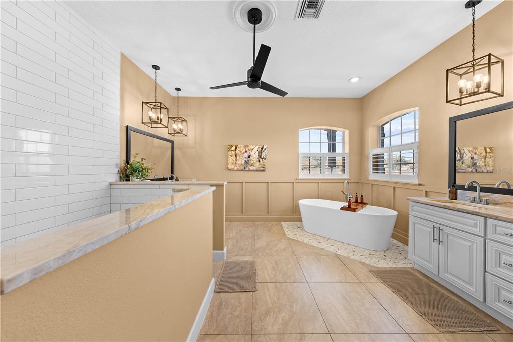 4231 Albritton Road St. Cloud, FL 34772 - Photo 38 of 94 a spacious bathroom with a tub sink and mirror