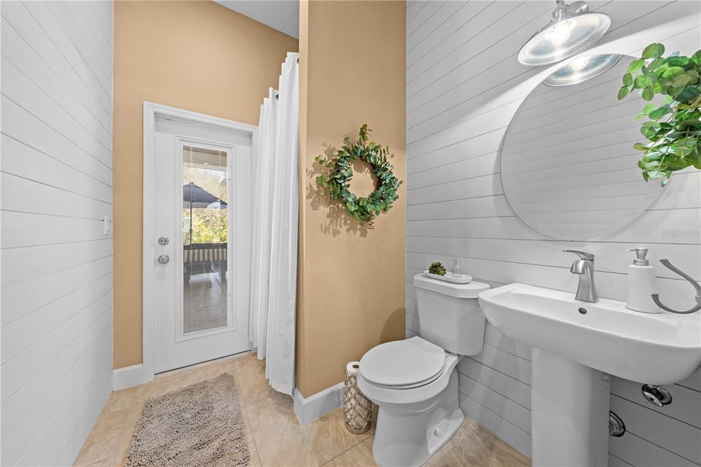 4231 Albritton Road St. Cloud, FL 34772 - Photo 44 of 94 a white toilet sitting next to a bathroom sink