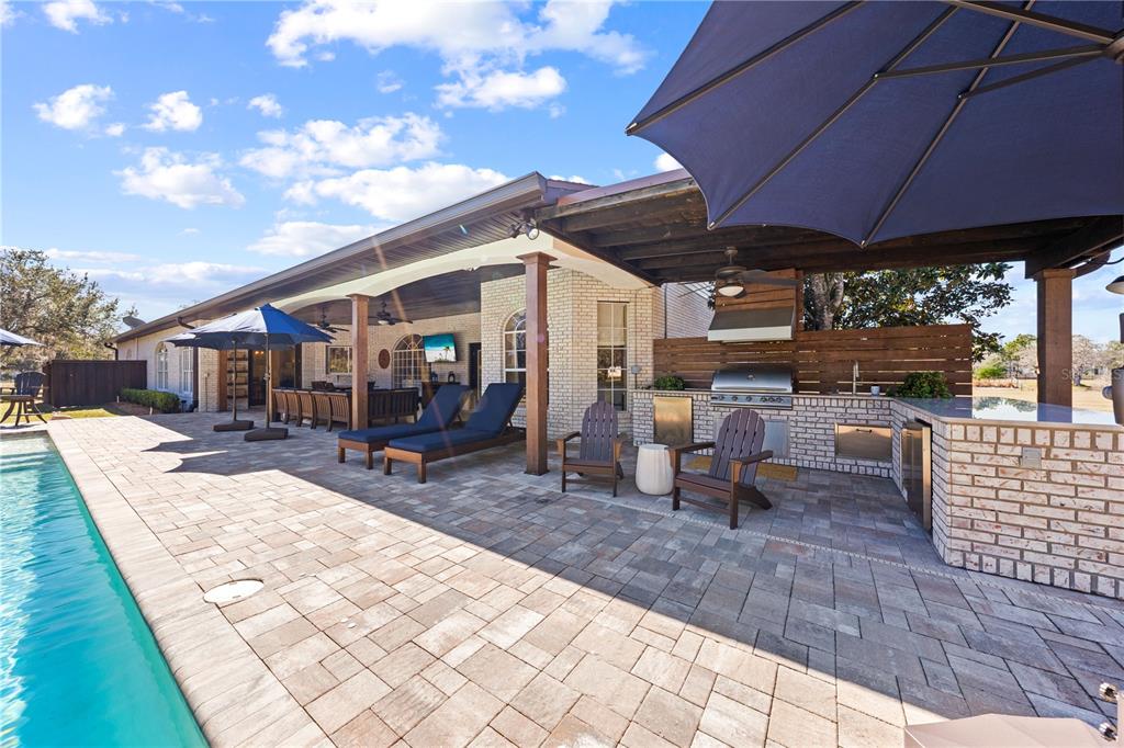 4231 Albritton Road St. Cloud, FL 34772 - Photo 64 of 94 a view of a patio with a table and chairs under an umbrella