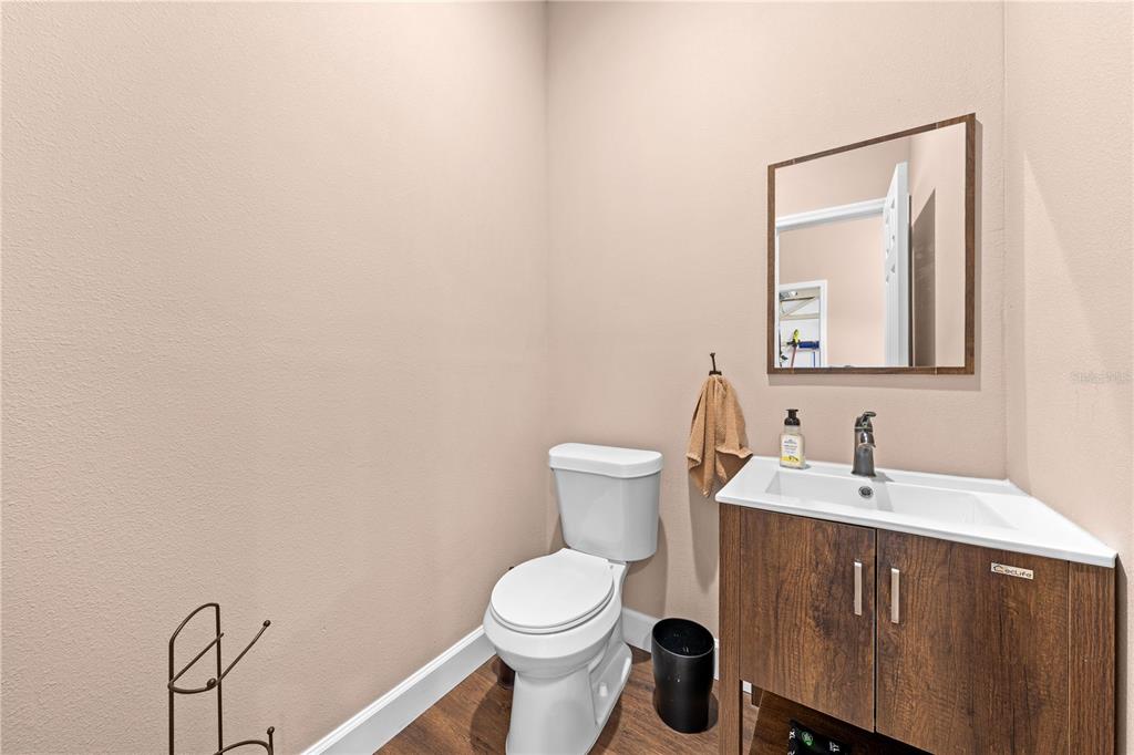 4231 Albritton Road St. Cloud, FL 34772 - Photo 73 of 94 a bathroom with a toilet a sink and mirror