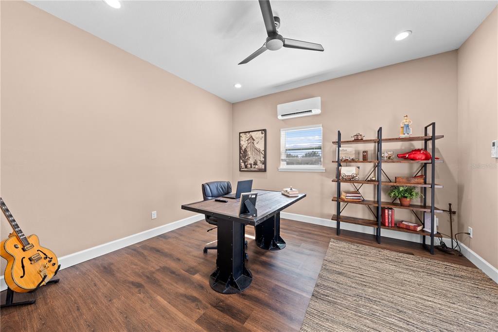 4231 Albritton Road St. Cloud, FL 34772 - Photo 75 of 94 a view of a workspace with furniture and wooden floor