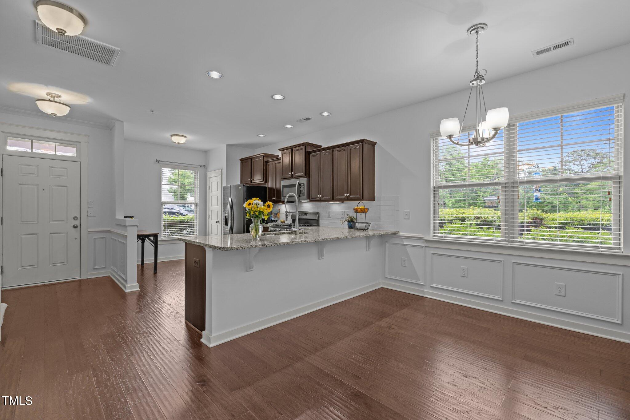 7871 Allscott Way Raleigh, NC 27612 - Photo 32 of 32 Open floor plan with dining space & counter area close to kitchen.