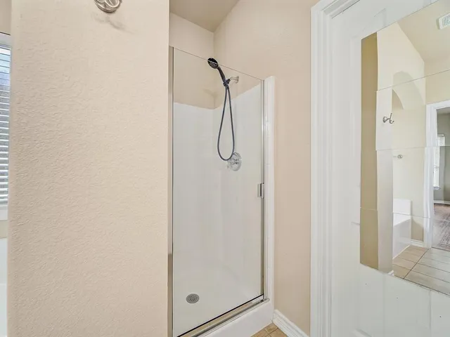 a bathroom with a glass shower door