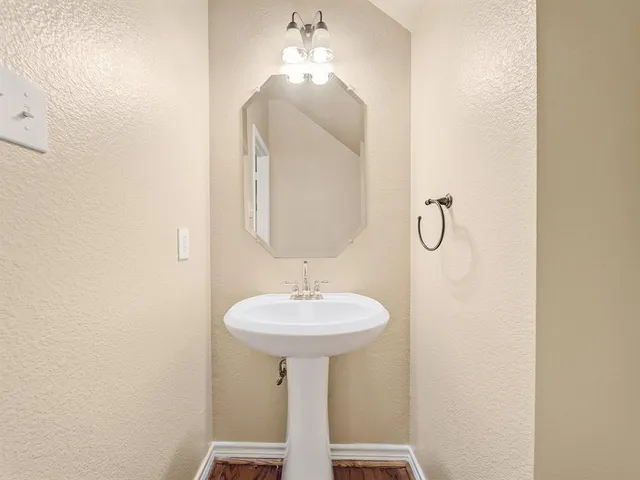 a bathroom with a sink a mirror and a shower