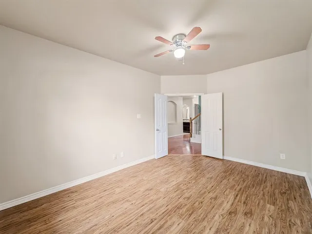 a view of a room with wooden floor closet and windows