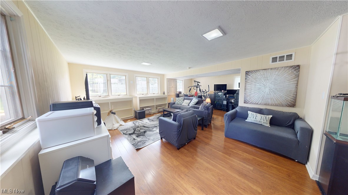 1071 Roland Road Lyndhurst, OH 44124 - Photo 14 of 30 Hardwood floored living room with a textured ceiling