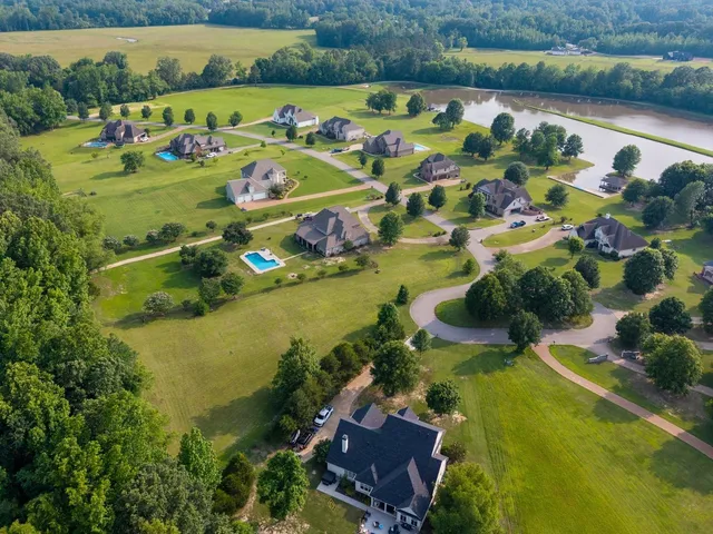 an aerial view of a house with a lake view