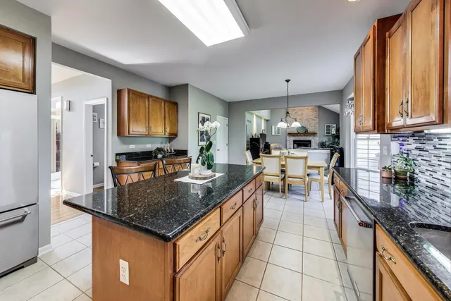 a kitchen with stainless steel appliances granite countertop a stove top oven a sink dishwasher and cabinets