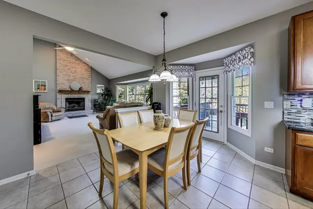 a dining room with furniture a chandelier and window