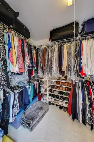 a view of walk in closet with clothes