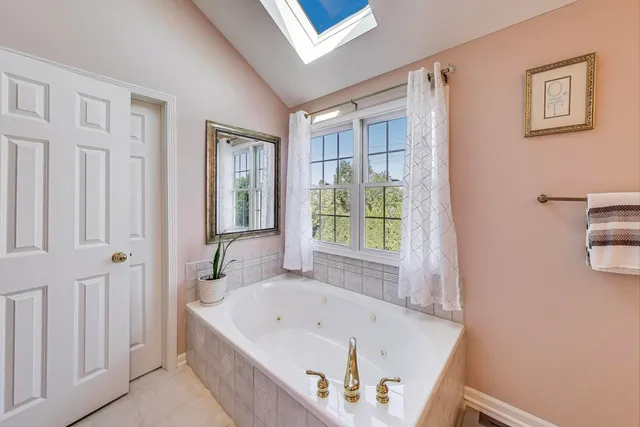 a bathroom with a tub and a window