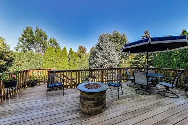a view of a balcony with chairs and wooden floor