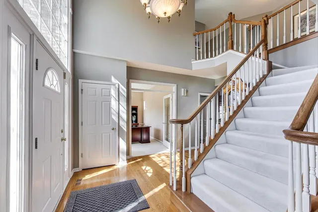 a view of entryway and hall with wooden floor