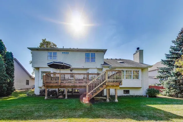 a view of a house with a yard balcony and sitting area