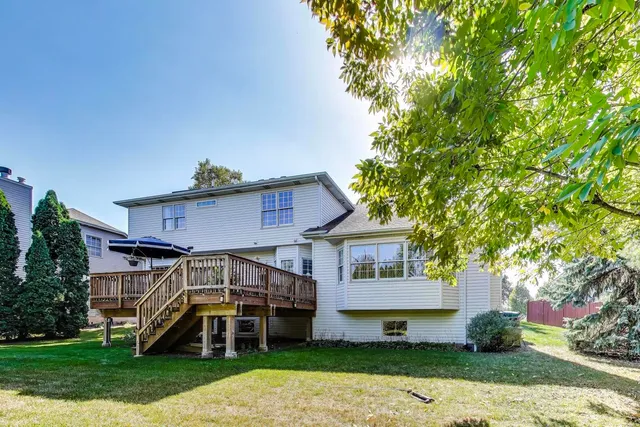 a front view of a house with a yard and potted plants