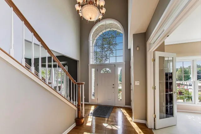 a view of hall way with wooden floor and staircase