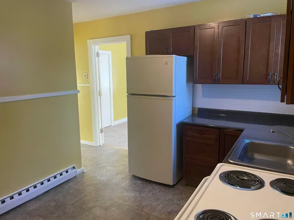 a kitchen with a refrigerator and a stove