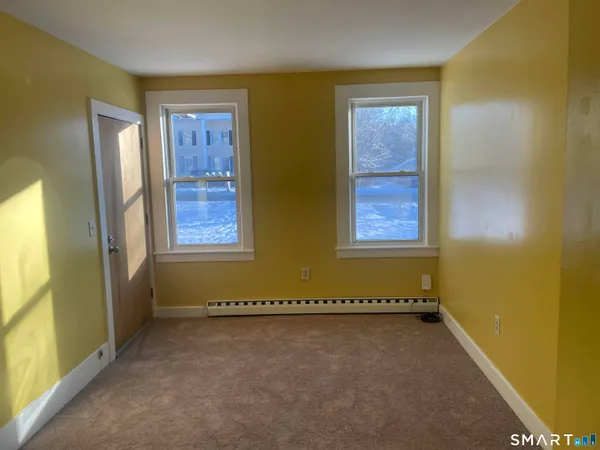 a view of a room with two windows