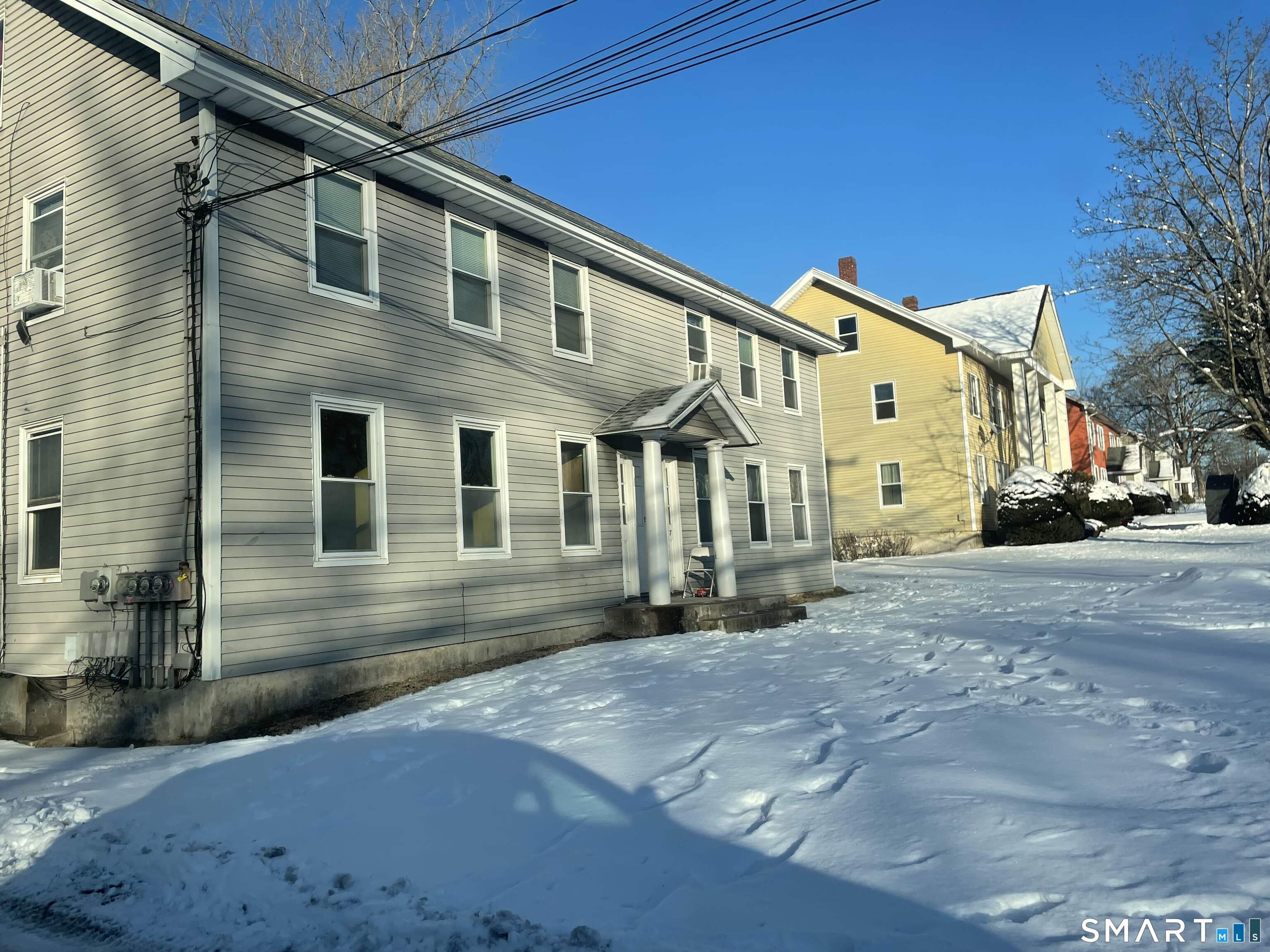 57 North Main Street, Unit D Windsor Locks, CT 06096 - Photo 6 of 7 a front view of a house with a yard