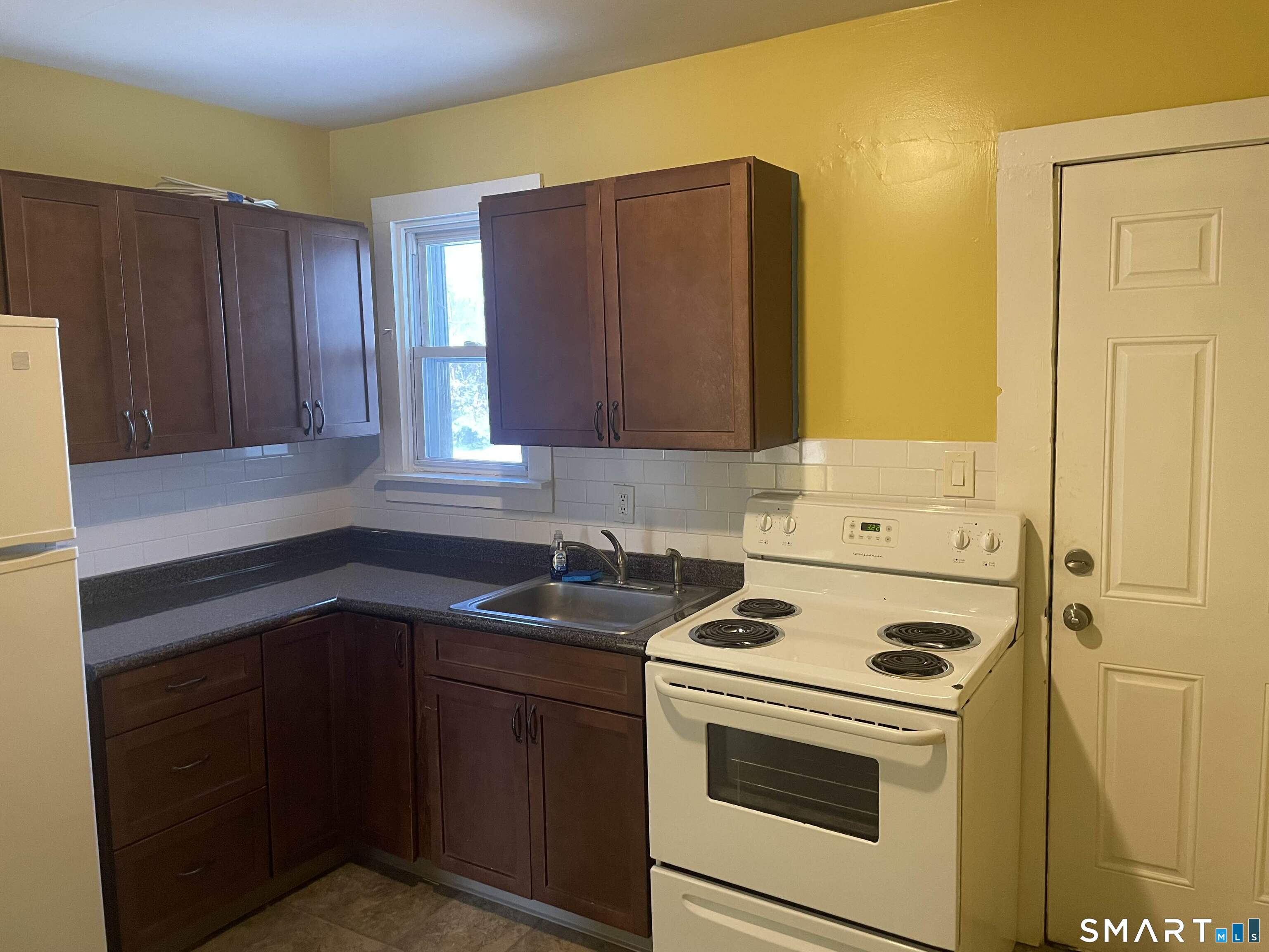 57 North Main Street, Unit D Windsor Locks, CT 06096 - Photo 7 of 7 a kitchen with a sink cabinets and appliances