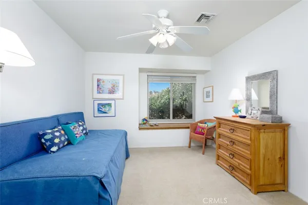 a bedroom with furniture and a dresser