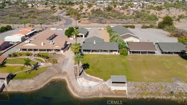 an aerial view of residential houses with outdoor space and swimming pool